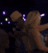 a man in a hat is holding the hand of a woman