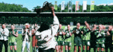 a group of soccer players are standing on a field and one has the number 5 on her shirt