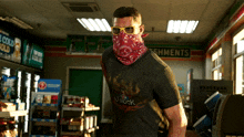 a man wearing sunglasses and a bandana in front of a sign for shments