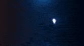 a glowing circle with smoke coming out of it on a dark blue background