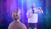 a man in a reindeer costume stands next to another man in a sailor outfit