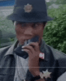 a close up of a police officer wearing a hat and vest