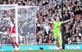 a soccer player in a green uniform is celebrating a goal