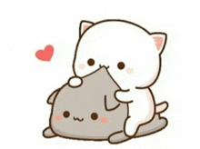 a white cat is holding a gray cat on top of a pillow .