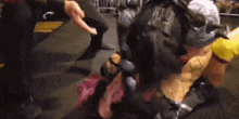 a group of people are standing around a statue of a man in a costume .