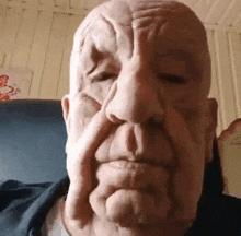 a man wearing a mask is making a funny face while sitting on a couch .