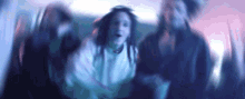 a blurry photo of a group of people dancing in a room .