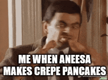 a man in a suit and tie is eating a crepe pancake .