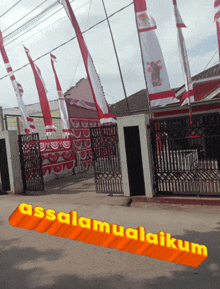 a sign that says ' assalamualaikum ' on it in front of a fence