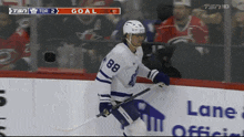 a hockey player with the number 88 on his jersey stands on the ice