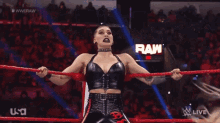 a female wrestler is in a wrestling ring with a usa logo in the background