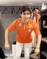 a man wearing an orange shirt that says hp on the front