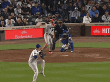 a baseball game is being played with a budweiser ad in the outfield