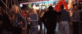a crowd of people are gathered in front of a sign that says ' a ' on it
