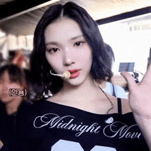 a woman wearing a black shirt that says midnight moon