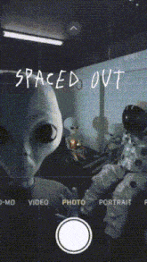 a video of an alien and an astronaut with the words spaced out written on the bottom