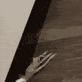 a close up of a person 's hand holding a piece of paper .