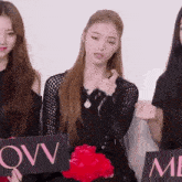 a woman holds up a sign that says ovv me