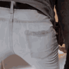 a close up of a person 's butt in white jeans .