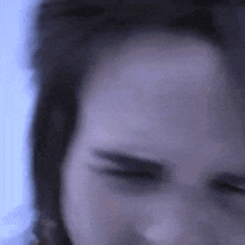 a close up of a person 's forehead with their eyes closed