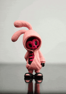 a pink bunny figurine with a skull on it 's chest