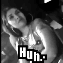 a black and white photo of a woman in a car with the words huh on the bottom