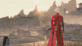 a man in a red outfit is standing in front of a landscape