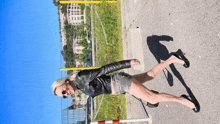 a woman wearing high heels and a leather jacket is walking down the road