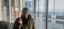 a man stands in front of a glass wall that says ' sss ' on it