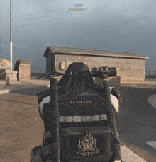 a person wearing a black vest with the word black gold on it