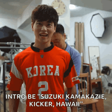 a man wearing a red korea jersey with the number 2