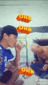 a man is drinking from a glass with the letters ohb above him