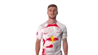 a man wearing a white shirt with a red bull on the front