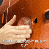 a close up of a person 's hand rubbing a glass with the words when in dough rub it out below it