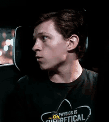 a man wearing a t-shirt that says " physics is cultural "