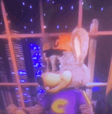 a chuck e cheese mascot looking out a window