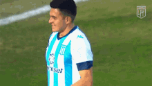 a soccer player wearing a blue and white striped shirt with the word eroset on it