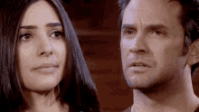 a man and a woman are looking at each other with tears coming down their faces