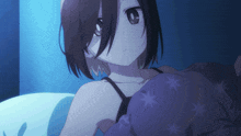 a girl laying in bed with a purple blanket with stars on it