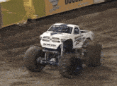 a white monster truck with the word ram on the front of it