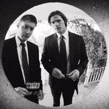two men in suits and ties are standing in a circle with fbi written on the bottom right
