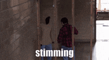 a man in a plaid shirt is standing next to another man with the word stunning written on the bottom