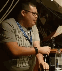 a man wearing glasses and a shirt that says ' hodge ' on it