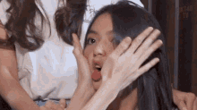 a woman is making a funny face with her tongue sticking out .