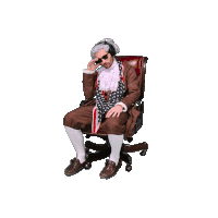 a man in a suit and tie is sitting on a black chair