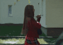 a silhouette of a woman in front of a plaid pattern