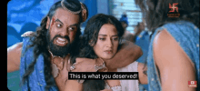 a man with a beard is hugging a woman with the words this is what you deserved