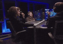 a group of people are playing a video game and one of their monitors says victory on it