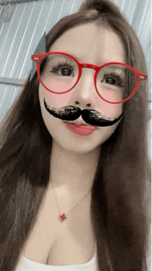 a woman wearing red glasses and a fake mustache on her face