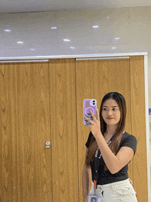 a woman is taking a picture of herself in a bathroom